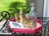 Gold animal print wine glasses and flutes on serving tray with fun elegant barware.